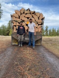 logging truck two team members