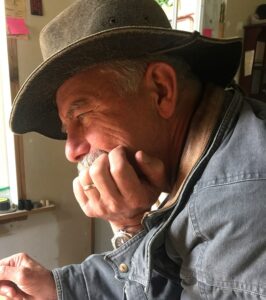 Older man resting his chin on his palm in a thoughtful position